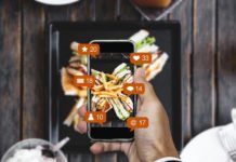 Taking food photograph by mobile smart phone, and sharing on social media, social network with notification icons